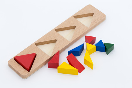 Wooden toy logic puzzle game isolated on white background