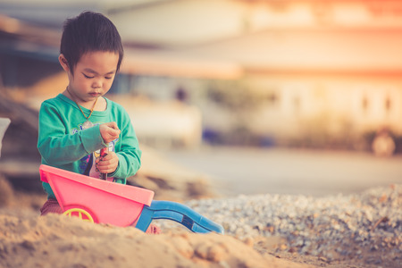 Little boy playing in sandbox, vintageの写真素材