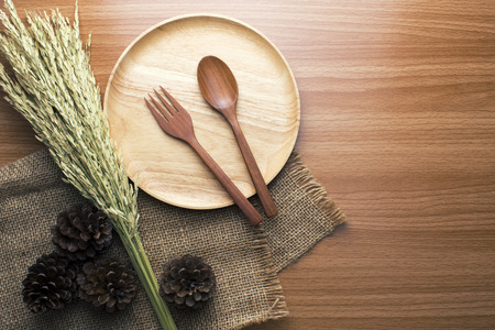 food wooden dinner dish and spoon, fork and decor top viewの写真素材