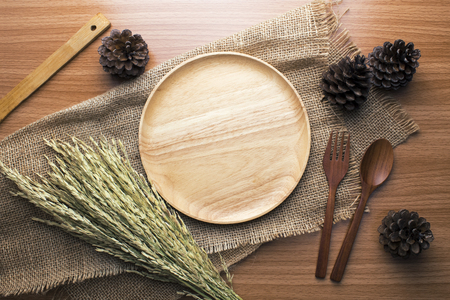food wooden dinner dish and spoon, fork and decor top viewの写真素材