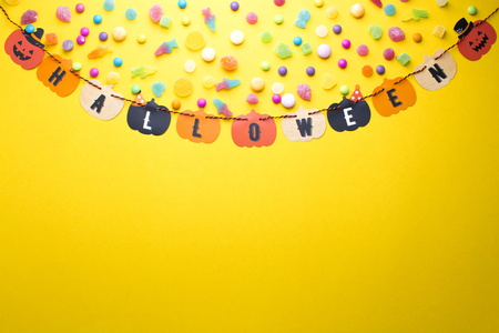 top view of halloween paper hanging with candyの写真素材