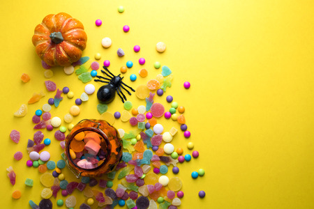 halloween candy colorful with decoration object on yellow groundの写真素材