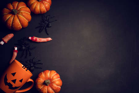 horror spooky funny ghost in halloween pumpkin holiday season greeting night celebration party with toy prop decoration in top view flatlay and trick of treat festival conceptの写真素材