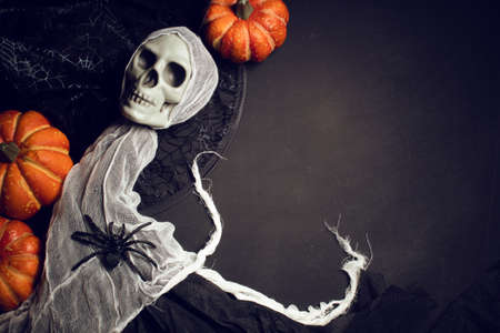 horror spooky funny ghost in halloween pumpkin holiday season greeting night celebration party with toy prop decoration in top view flatlay and trick of treat festival conceptの写真素材
