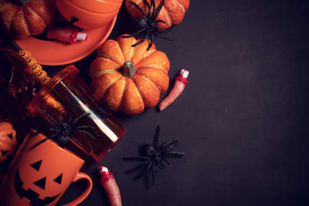 horror spooky funny ghost in halloween pumpkin holiday season greeting night celebration party with toy prop decoration in top view flatlay and trick of treat festival conceptの写真素材