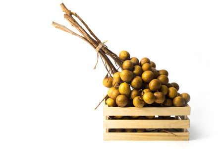 longan isolated white background fruit in wood boxの写真素材
