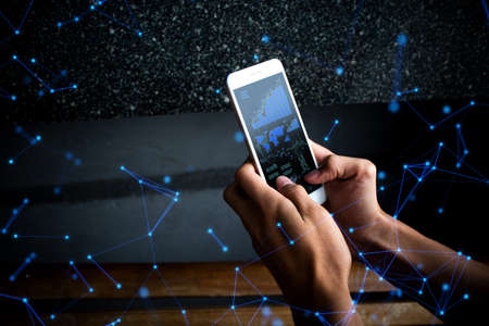 businessman hand use the smartphone device online to network social internet of things concept, data deep learning ai ui, hacker on server system, digital trade risk workingの写真素材