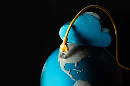 world map globe with internet server online yellow lan wire on black background in technology digital connection with business aroun the world conceptの写真素材