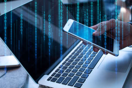 businessman with smartphone mobile and laptop notebook computer in network online hologram connect to data concept with social, data deep learning ai, robotic system, internet of things, hacker and securityの写真素材