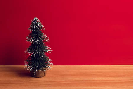 merry christmas tree with wood ground and red background