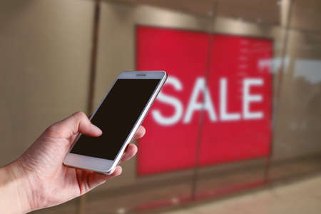 hand holding network online smartphone device application for buy product in black friday shopping...