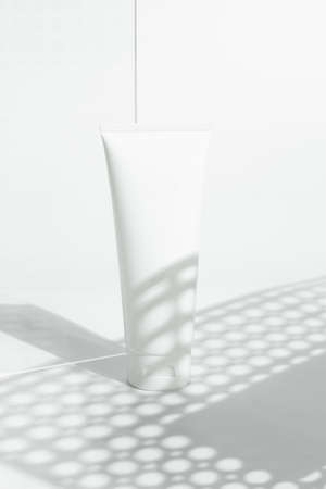 fresh beauty spa medical skincare and cosmetic lotion cream facial tube bottle packaging product on white decor background with summer season sun lightの写真素材