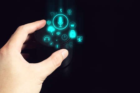 businessman push on ai smart home device automation voice speaker technology to control network digital data for modern livingの写真素材