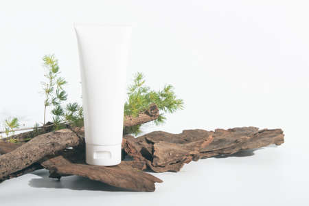 beauty spa medical skincare and cosmetic lotion bottle cream packaging product on white decor background with herbal wood branchの写真素材