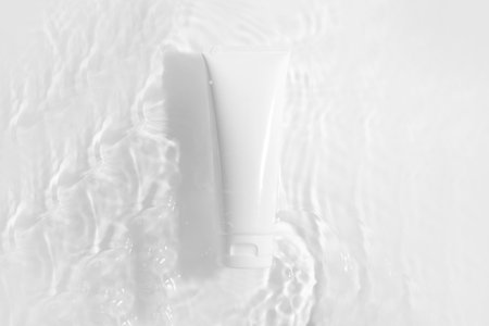 beauty spa medical skincare cosmetic bottle tube packaging on water wave flow fresh with white background on sunlight summer season conceptの写真素材