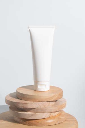 cosmetic mockup cream bottle pakage with beauty spa treatment concept on white background wood dish plateの写真素材