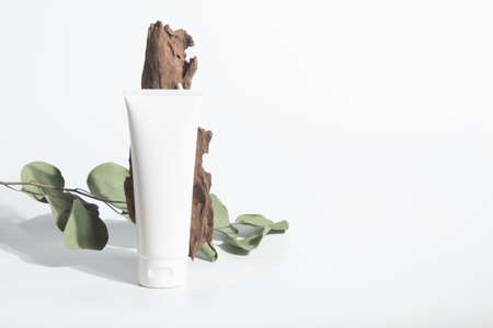 cosmetic mockup cream bottle pakage with beauty spa treatment concept with herb leaf tree wood branchの写真素材
