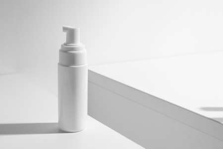 mockup of beauty spa medical skincare concept, cosmetic spray cream bottle packaging with white decor background tableの写真素材