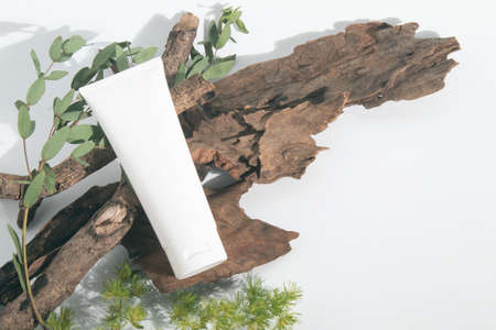 beauty spa medical skincare and cosmetic lotion bottle cream packaging product on white decor background with herbal wood branchの写真素材