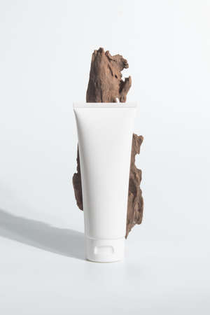 cosmetic mockup cream bottle pakage with beauty spa treatment concept with herb tree wood barkの写真素材