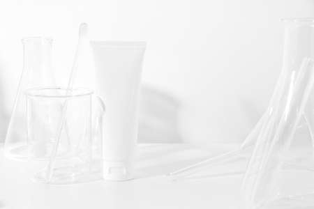 cosmetic mockup cream in bottle pakage with beauty spa treatment with science lab test tubeの写真素材