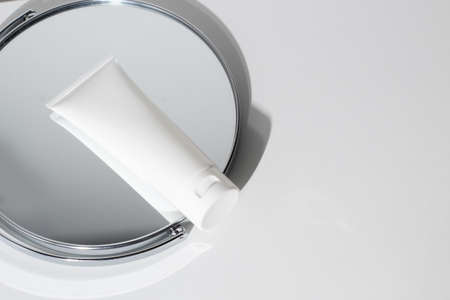 mockup lotion cream facial beauty spa cosmetic tube pakage container with mirror and background top...