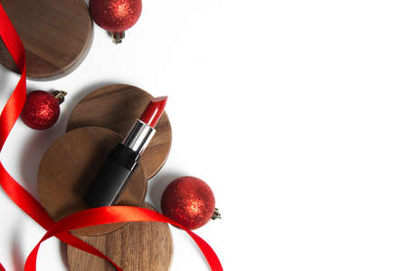 gloss red rose lipstick cosmetic beauty fashion with vintage wood plate dish, luxury makeup product, white background, package container mockup, celebration gift ribbon and glitter ball decorationの写真素材