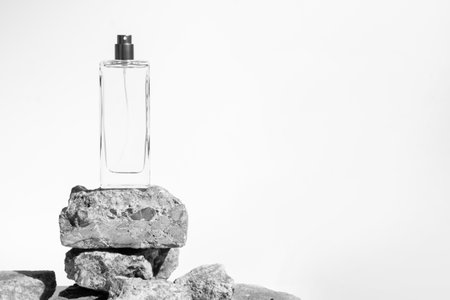 luxury perfume bottle glass packaging with stone rock concrete grunge on white background, aroma smell of cosmetic beauty container clearの写真素材
