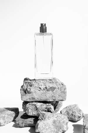 perfume bottle glass luxury packaging with stone rock concrete grunge on white background, aroma smell of cosmetic beauty containerの写真素材