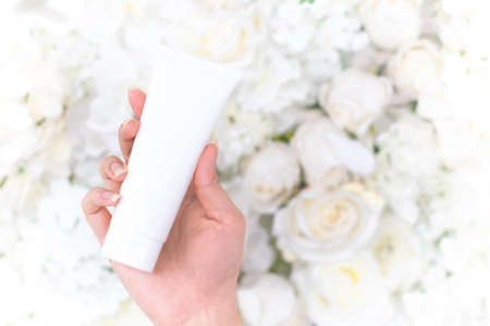 top view of medical skincare treatment spa cosmetic spf body lotion facial foam tube package product mockup with white decoration and herb flower rose backgroundの写真素材