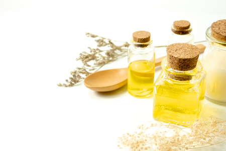 oil organic with cosmetic spa mockup bottle and wood spoon with dried flower caspia in beauty skincare treatment healthy concept, top view of nutrition lemon extract for facialの写真素材