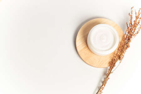 spa cream lotion facial herbal with dried flower with wood dish on white background in beauty cosmetic treatment conceptの写真素材