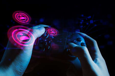 gamer boy with hand holding the joystick controller electronic for playing game with online network...