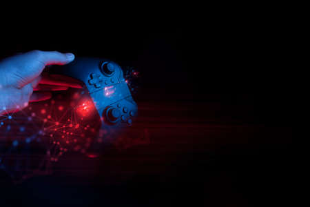 gamer boy with hand holding the joystick controller electronic for playing game with online network...