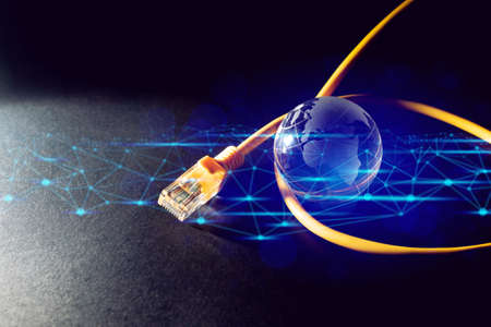 mini global glass with internet server online yellow lan wire on black background in technology digital connection with business aroun the world conceptの写真素材