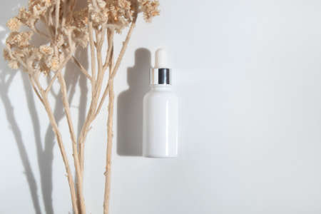 mockup of beauty fashion cosmetic makeup bottle serum dropper product with skincare healthcare concept on backgroundの写真素材