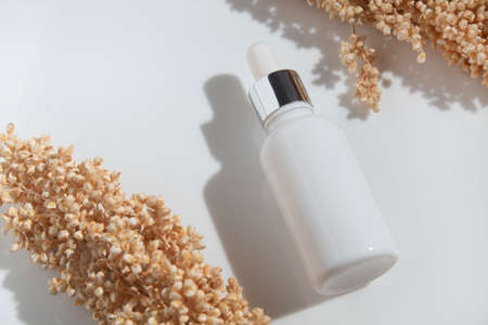 mockup of beauty fashion cosmetic makeup bottle serum dropper product with skincare healthcare concept on backgroundの写真素材