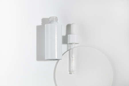 mockup of beauty fashion cosmetic makeup bottle serum dropper product with skincare healthcare concept on backgroundの写真素材