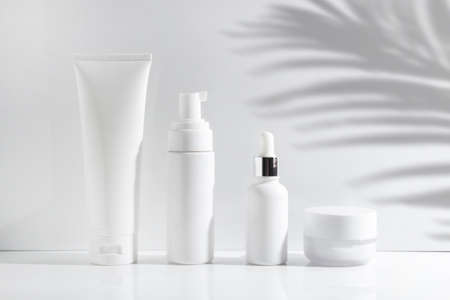 mockup of beauty fashion cosmetic makeup bottle lotion product with skincare healthcare concept on summer palm leaf tree backgroundの写真素材