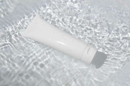 mockup of beauty fashion cosmetic makeup bottle lotion product with skincare healthcare concept on water pool backgroundの写真素材