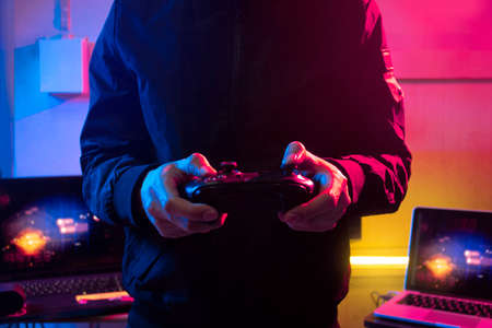 gamer playing game by joystick with computer, gaming and esports challenge, streaming online, tournament conceptの写真素材