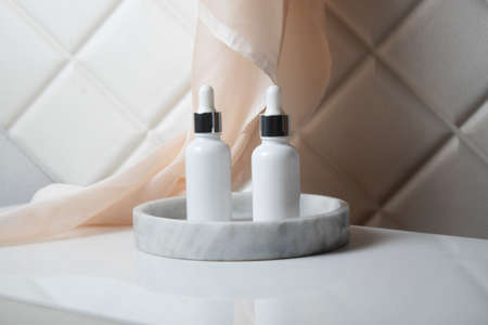 mockup of beauty fashion cosmetic makeup bottle lotion  serum product with skincare healthcare concept on backgroundの写真素材