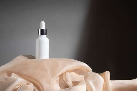 white wood table background with fabric textile, cosmetic makeup bottle lotion cream product with beauty fashion skincare healthcare mockupの写真素材