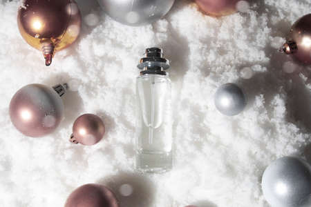 white snow background with lifestyle, cosmetic makeup bottle lotion cream product mockup with beauty fashion skincare for merry christmas festival giftの写真素材