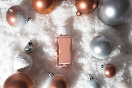white snow background with lifestyle, cosmetic makeup bottle lotion cream product mockup with beauty fashion skincare for merry christmas festival giftの写真素材
