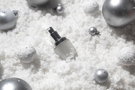 white snow background with lifestyle, cosmetic makeup bottle lotion cream product mockup with beauty fashion skincare for merry christmas festival giftの写真素材