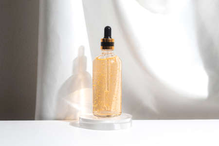 container bottle product of golden extract cream lotion, medical skincare facial, branding mockup display on white backgroundの写真素材