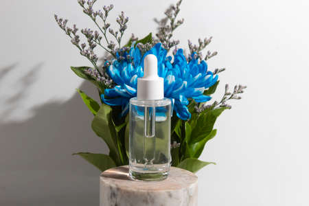 mockup tube bottle for skin care cosmetic, product branding, serum dropper cream lotion treatment with natural flowerの写真素材