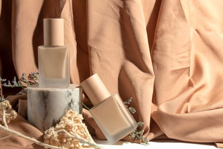 mockup tube bottle for skin care cosmetic, product branding, serum dropper cream lotion treatment with natural flowerの写真素材