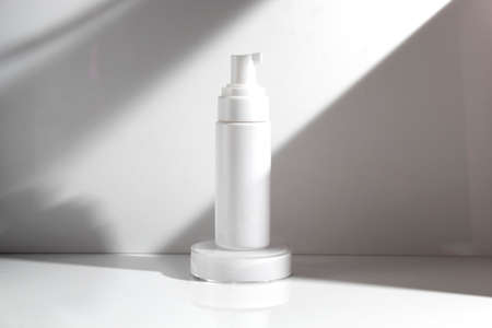 mockup tube bottle for skin care cosmetic, product branding, serum dropper cream lotion treatment with natural flowerの写真素材